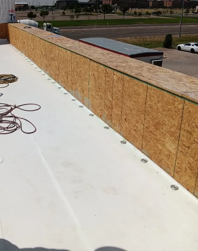 CRS crew installing TPO membrane on an Amarillo commercial building
